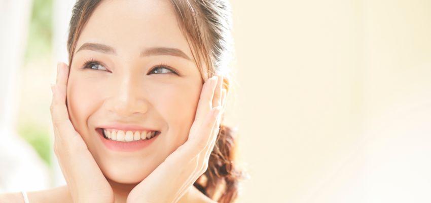 The woman's skin glows after using natural skin treatments.