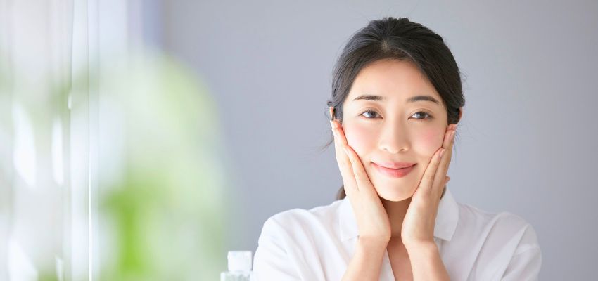 Woman showing radiant complexion supported by natural beauty remedies