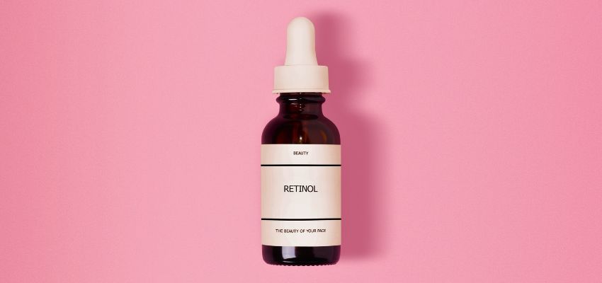 Skincare product comparison concept showing retinol serum bottle for tretinoin vs retinol benefits.