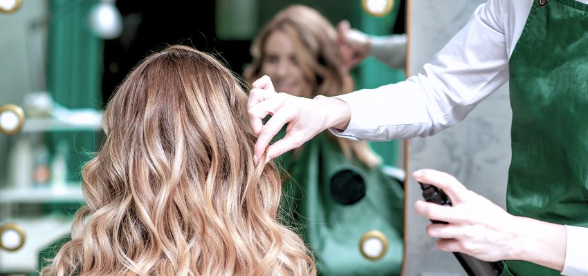 Hairstylist creating beautiful bronde hair in a professional salon setting