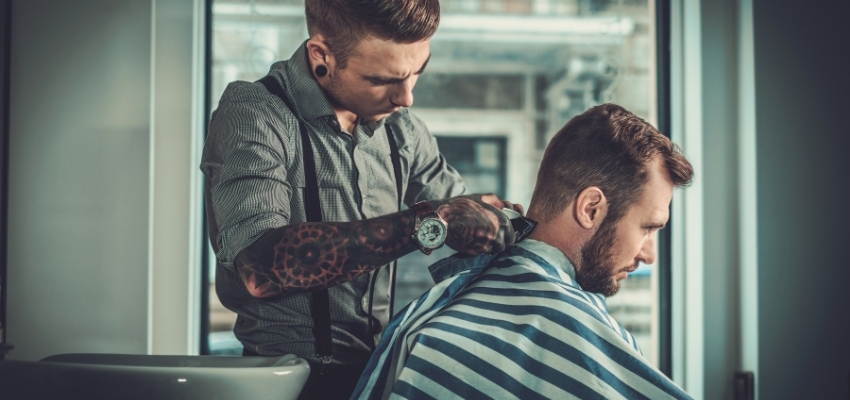 Barbers use clippers and specialized tools to create seamless skin fades.