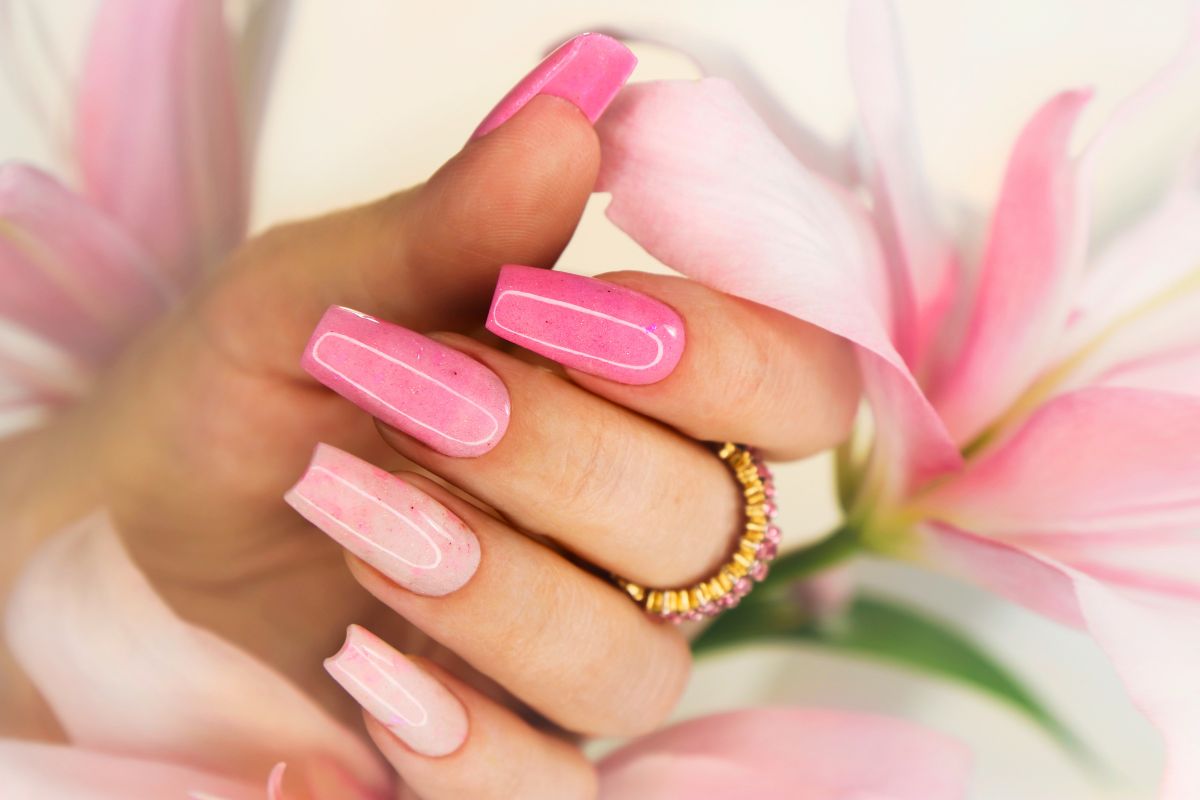 Beautiful pink manicured nails showing the healthy natural result after successfully completing how to remove gel x nails.