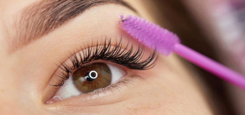 classic-lash-extensions (1) Close-up of a finished eye with classic lash extensions being brushed for perfect separation.